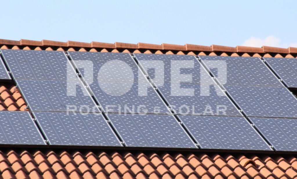 Solar panels installed on red clay tile roof for renewable energy generation