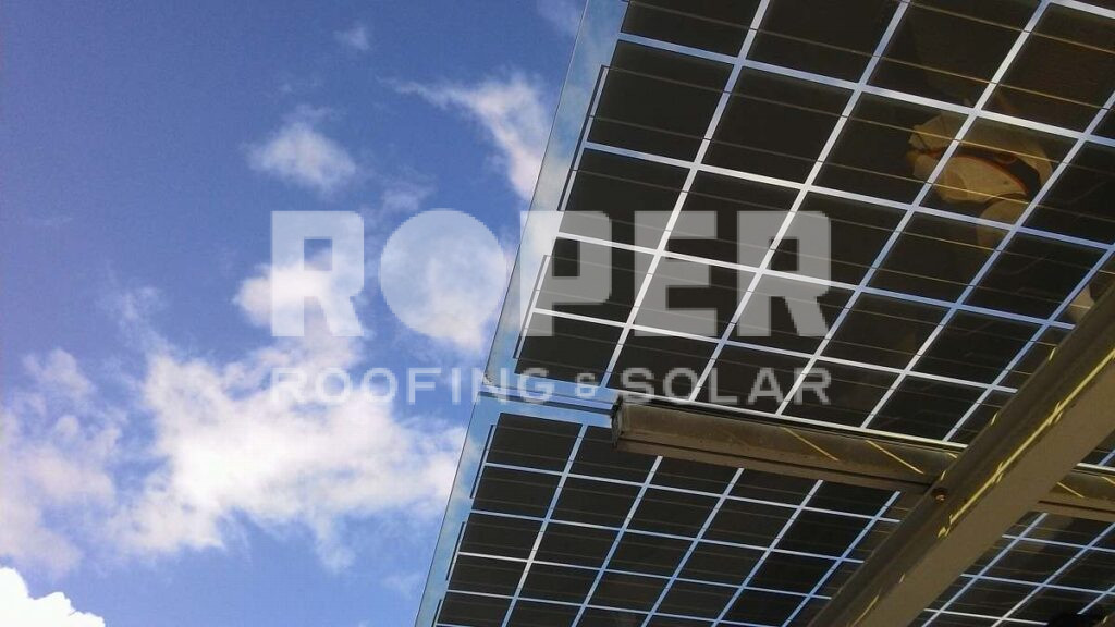 Solar panels mounted on building structure against blue sky with white clouds