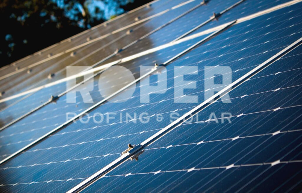 Blue solar panels on roof generating renewable energy for home electricity