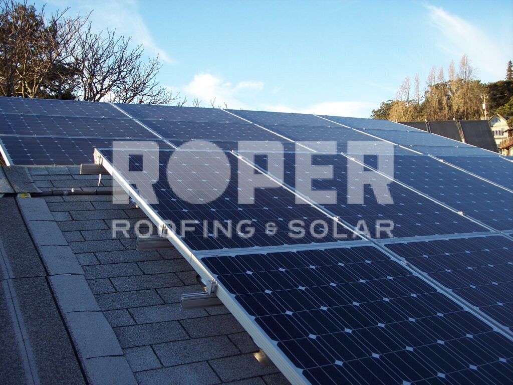Solar panels installed on residential roof with blue sky background
