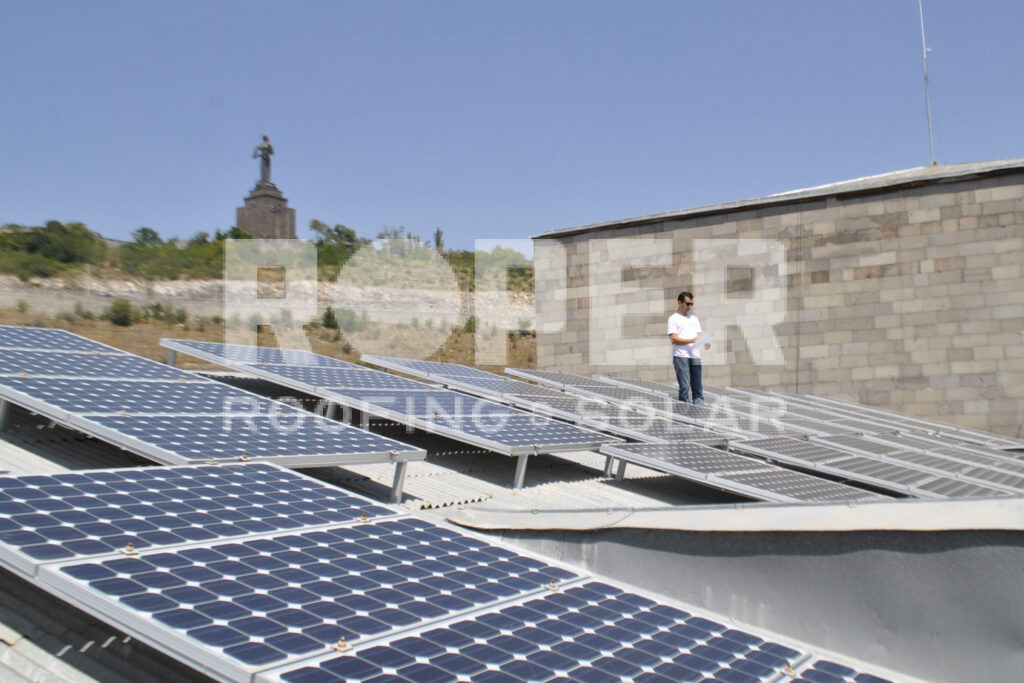 Solar panel installation on rooftop with person inspecting renewable energy system