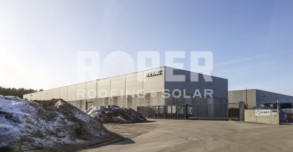 Modern REVAC industrial facility with concrete facade and snow-covered landscape