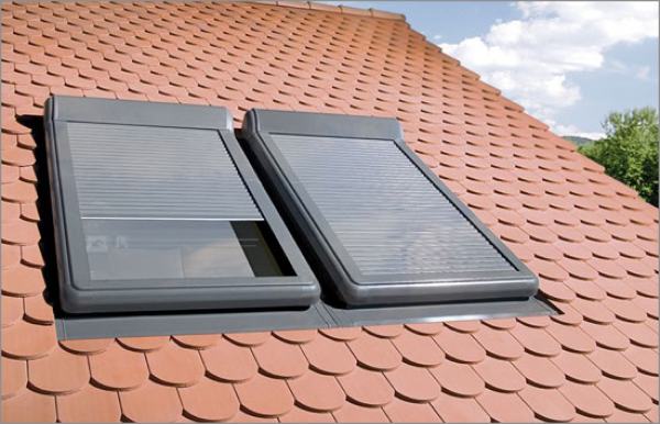 Two modern skylights installed on red clay tile roof with external blinds