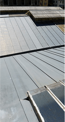 Gray concrete roof panels on flat commercial building under construction